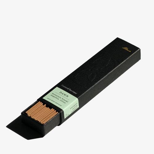 A right angle view of A partially open black rectangular box showing brown incense sticks inside.