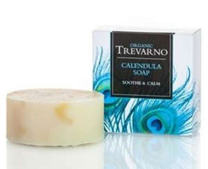 cream round bar of soap, white square box with blue feathers, black label, blue writing, trevarno organic calendula soap