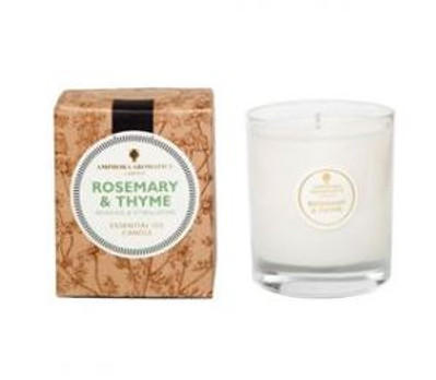 ivory candle in clear glass pot with natural brown box labelled amphora rosemary and thyme