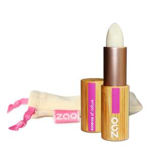 Open lip balm stick in bamboo tube, natural cotton pouch shown behind, label shows ZAO