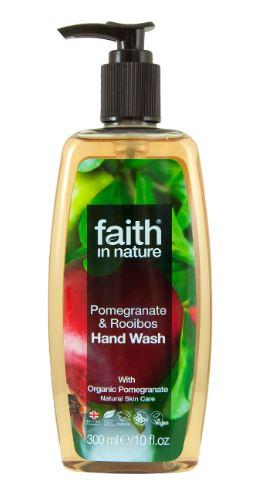 A clear plastic bottle with black pump dispenser. Label has photo image of pomegranate fruit and trees. Label shows faith in nature pomegranate and rooibos hand wash.