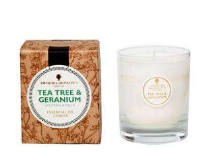 ivory candle in clear glass pot with natural brown gift box labelled amphora  tea tree and geranium