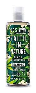 A clear plastic bottle and cap, decorated label with graphic images of green hemp leaves and cream flowers. Label shows hemp and meadowfoam shampoo.