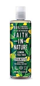 A clear plastic bottle with white cap. Dark green label decorated with images of lemons and green leaves. Label shows faith in nature lemon and tea tree shampoo in white writing.