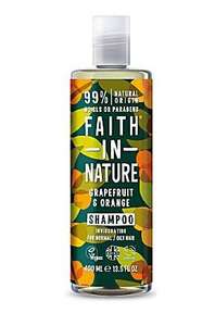 Clear plastic bottle with white cap. Decorative  dark label with round orange images and green leaf images. Label shows faith in nature orange and grapefruit shampoo.