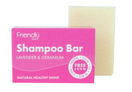 A bright pink box with white labelling next to a natural cream coloured rectangle bar of  soap. Labelling shows, Friendly Soap, Shampoo Bar.