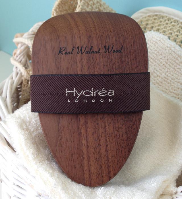 Top of cellulite massager showing dark brown walnut wood and black hand strap across.