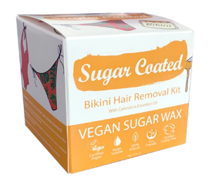 A white and orange square box with drawn images of bikini bottoms and waxing jars. Label shows sugar coated bikini hair removal kit