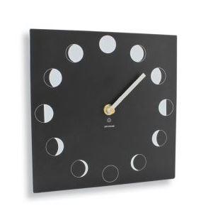 black  slate like square clock with white hand showing moon phases around it