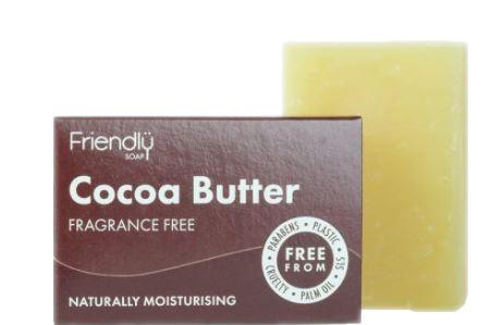 Small rectangular brown box soap packet, showing white text friendly soap cocoa butter fragrance free. Cream natural rectangular soap bar stood behind.