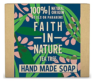 A natural brown rectangle card box with blue background illustrated with green leaves and pink flower blossoms, text on box shows faith in nature tea tree hand made soap.