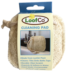 A small square natural loofah pad with yellow card wrap label showing loofco cleaning pad