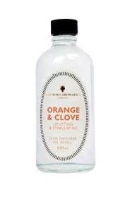 clear glass bottle showing amphora orange and clove reed refill