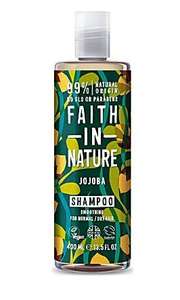 Clear plastic bottle with white cap. Dark green label decorated with green leaves. Label shows faith in nature jojoba shampoo.