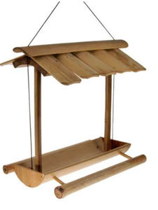 A hanging bird feeder with long rounded bamboo tray and perches. Bamboo roof.