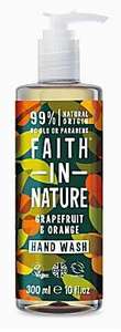 A clear pump dispenser bottle with decorative orange and grapefruit labelling with green leaves. label shows faith in nature grapefruit and orange hand wash.