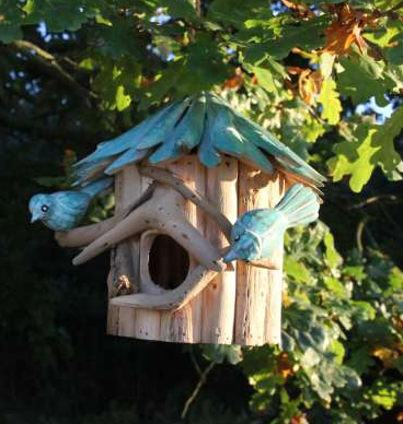 hanging birdhouse made from driftwood. Blue driftwood roof, natural driftwood box, two wooden perches with blue carved birds.