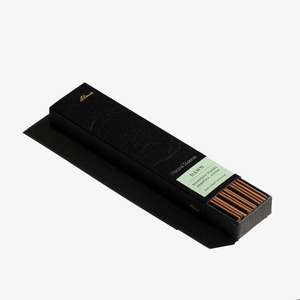 A partially open black rectangular box showing brown incense sticks inside.