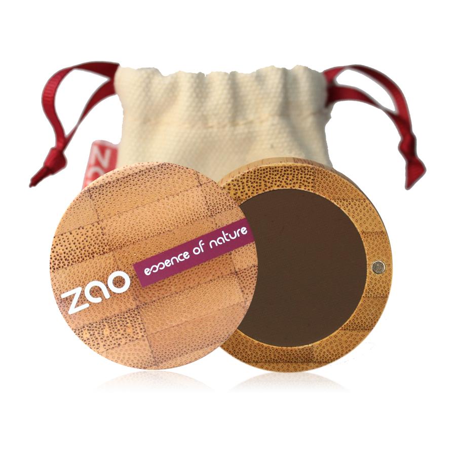 Brown eyebrow powder shown in open bamboo compact case, natural cotton pouch behind, label shows Zao.