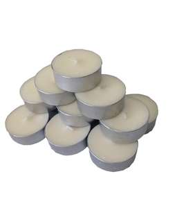 White coloured tealights in aluminium cases stacked in a pile