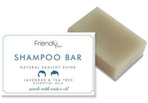 A natural cream rectangle shampoo bar, next to card box packaging of white and blue. Label shows friendly soap shampoo bar lavender and tea tree.