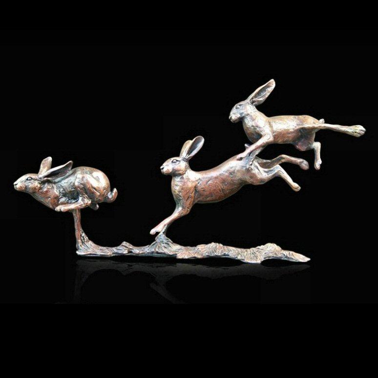 Small Hares Running (801) in bronze by Michael Simpson