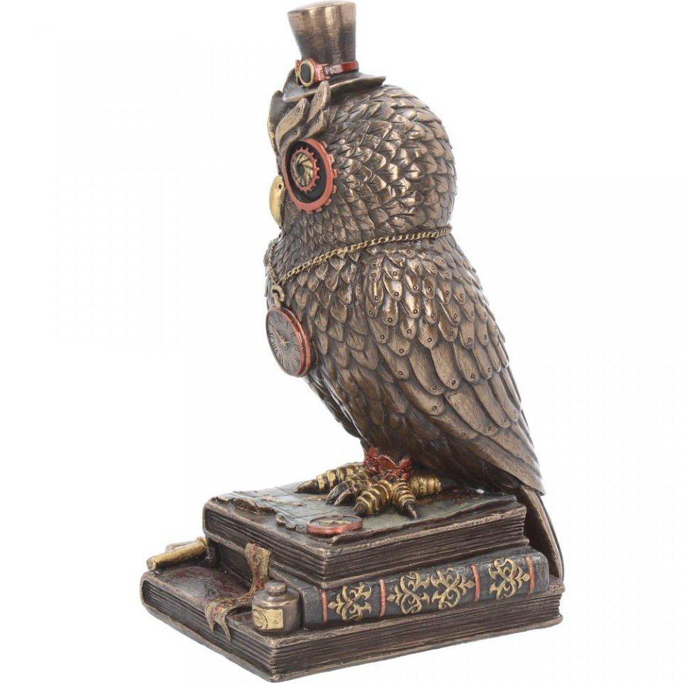 Standing on a stack of leather-bound books, this mechanical owl is almost the real thing. Metallic wings folded at their side, individual feathers riveted on, a red clock hangs from a gold chain around their neck. Eyes shaped like large red cogs have a golden shutter at the centre, and are topped with large brass eyebrows. Sitting on top is a small top hat with goggles sitting on top, while around the books, a map and some navigator’s tools are scattered. Cast in the finest resin before being painstakingly hand-painted, this Steampunk figurine is the perfect companion to have aboard your airship.