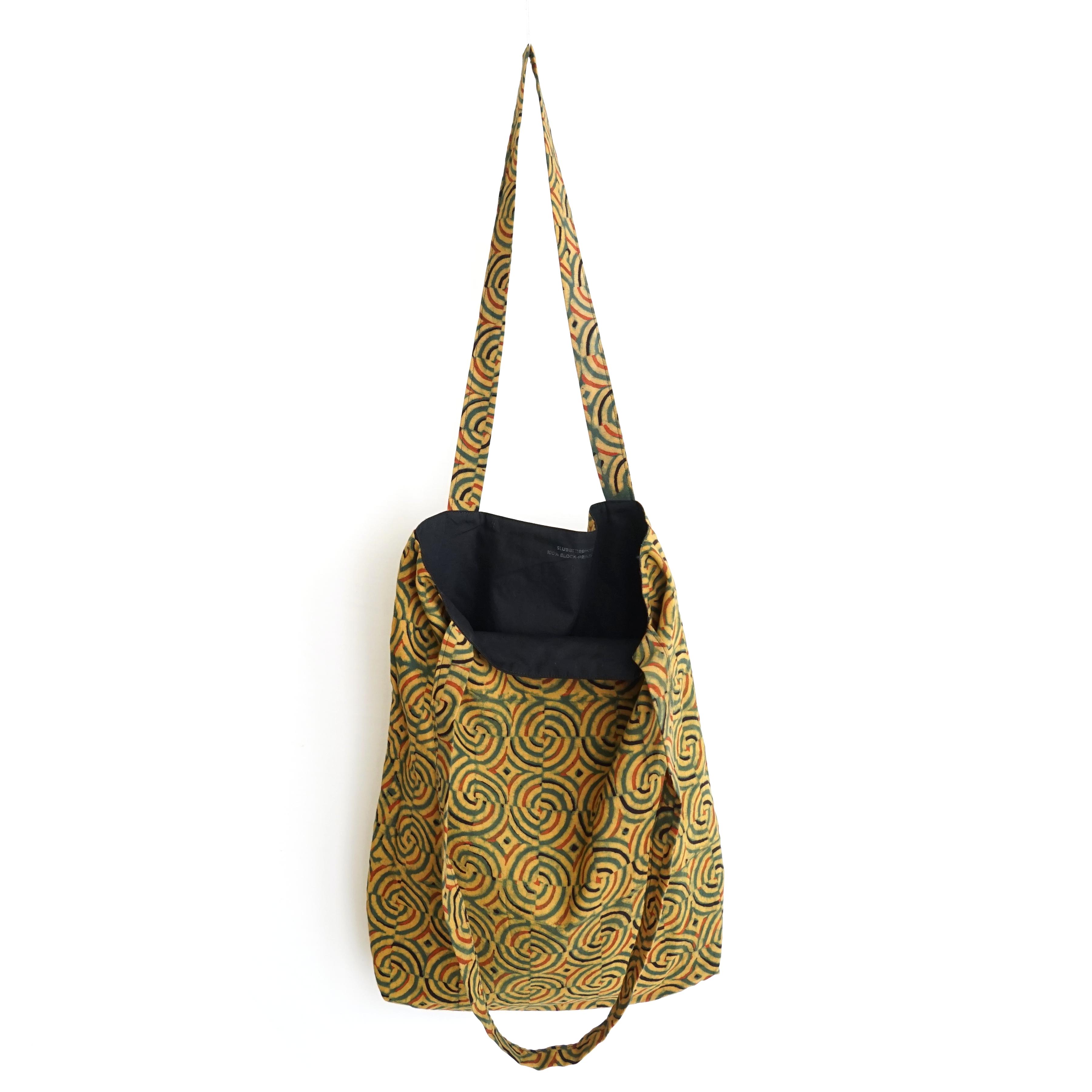block printed cotton tote bag, natural dye, yellow, green red black spiral design, lined with black cotton, open