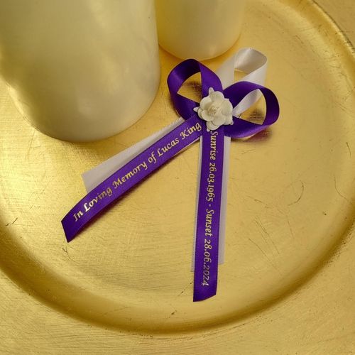 Purple funeral ribbon with rose to wear on lapel for memorial