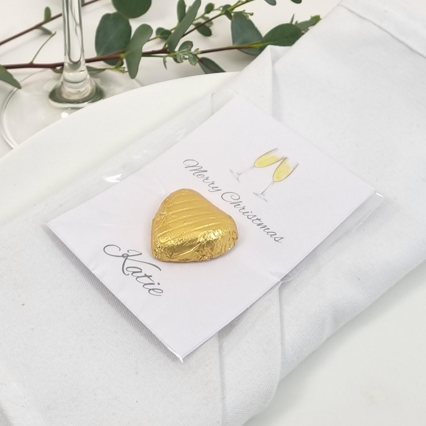 Gold Christmas table favours with champagne glasses artwork