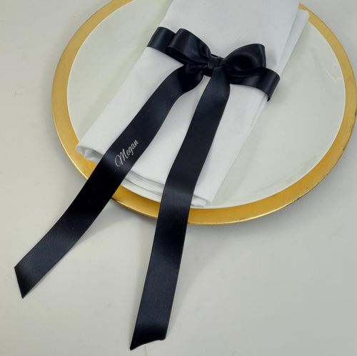 Pre tied Black and white and gold napkin ribbon bow with long tails and printed guest names on ribbon for weddings
