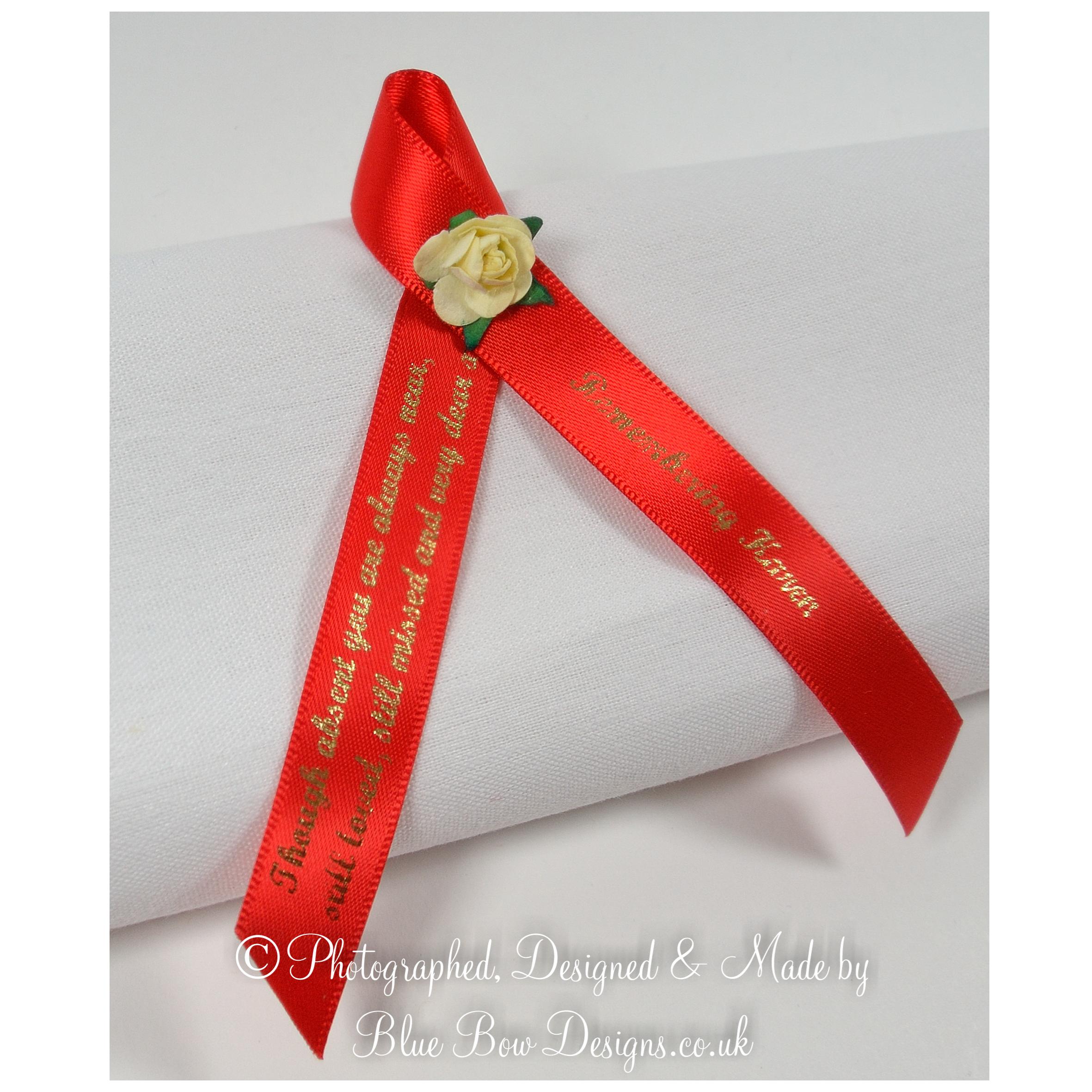 Red memorial ribbon with rose