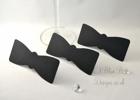 Three matt black tie place cards with stands for formal dinner party