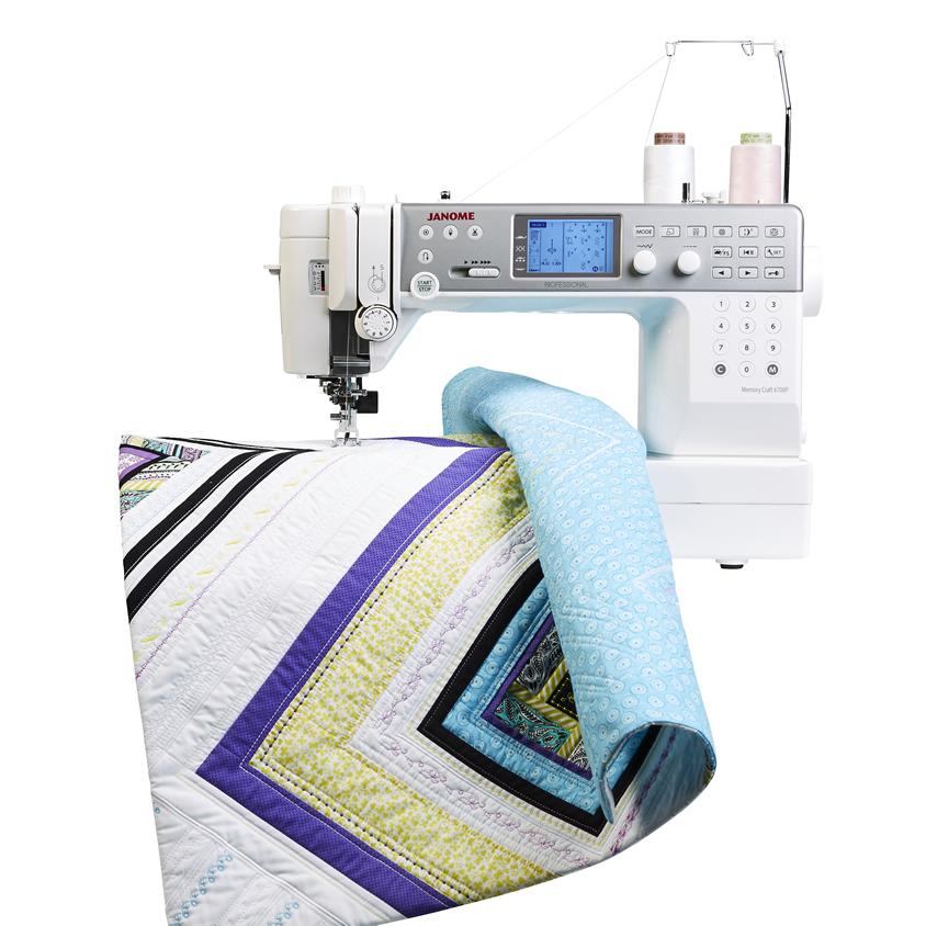 Janome Memory Craft 6700P Sewing Machine with a quilt