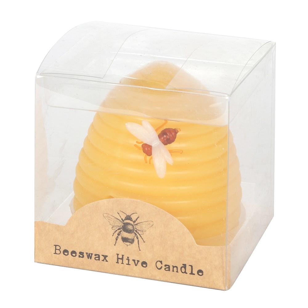 Yellow beeswax hive shaped candle with a bee on the side, shown in transparent box.