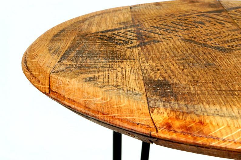 A rustic bourbon barrel head side table, close up.