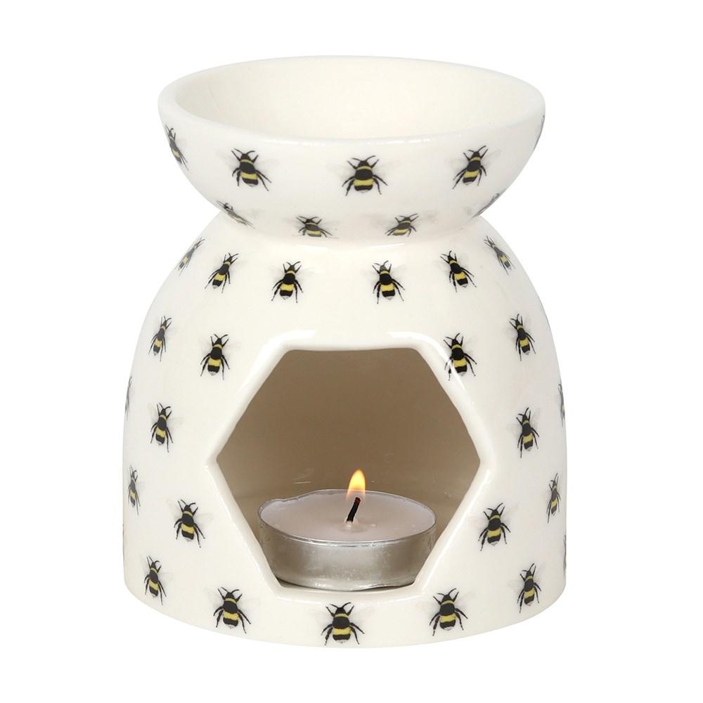 All Over Bee Print Ceramic Oil Burner holding a lit tealight candle.