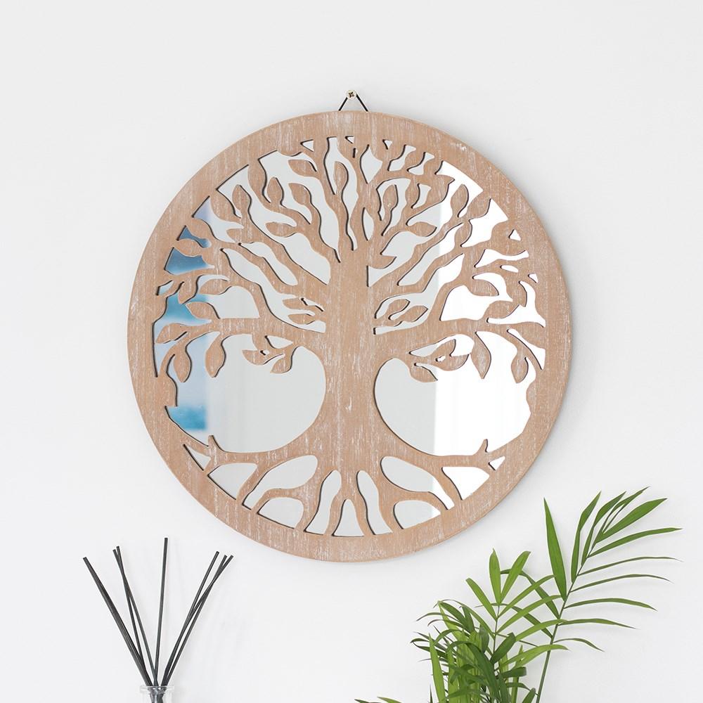 Round 40cm tree of life mirrored wall decoration, with a detailed cut out silhouette of the tree of life, on a white wall.
