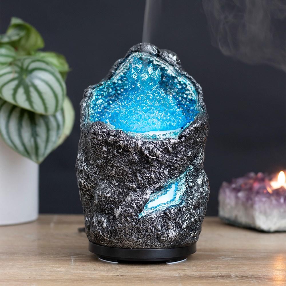 Blue Crystal Cave Electric Aroma Diffuser, featuring a faux geode with glowing inner blue crystal cave, on a wooden surface.
