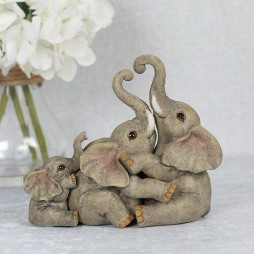 Elephant family ornament, featuring two parents and their baby cuddling.
