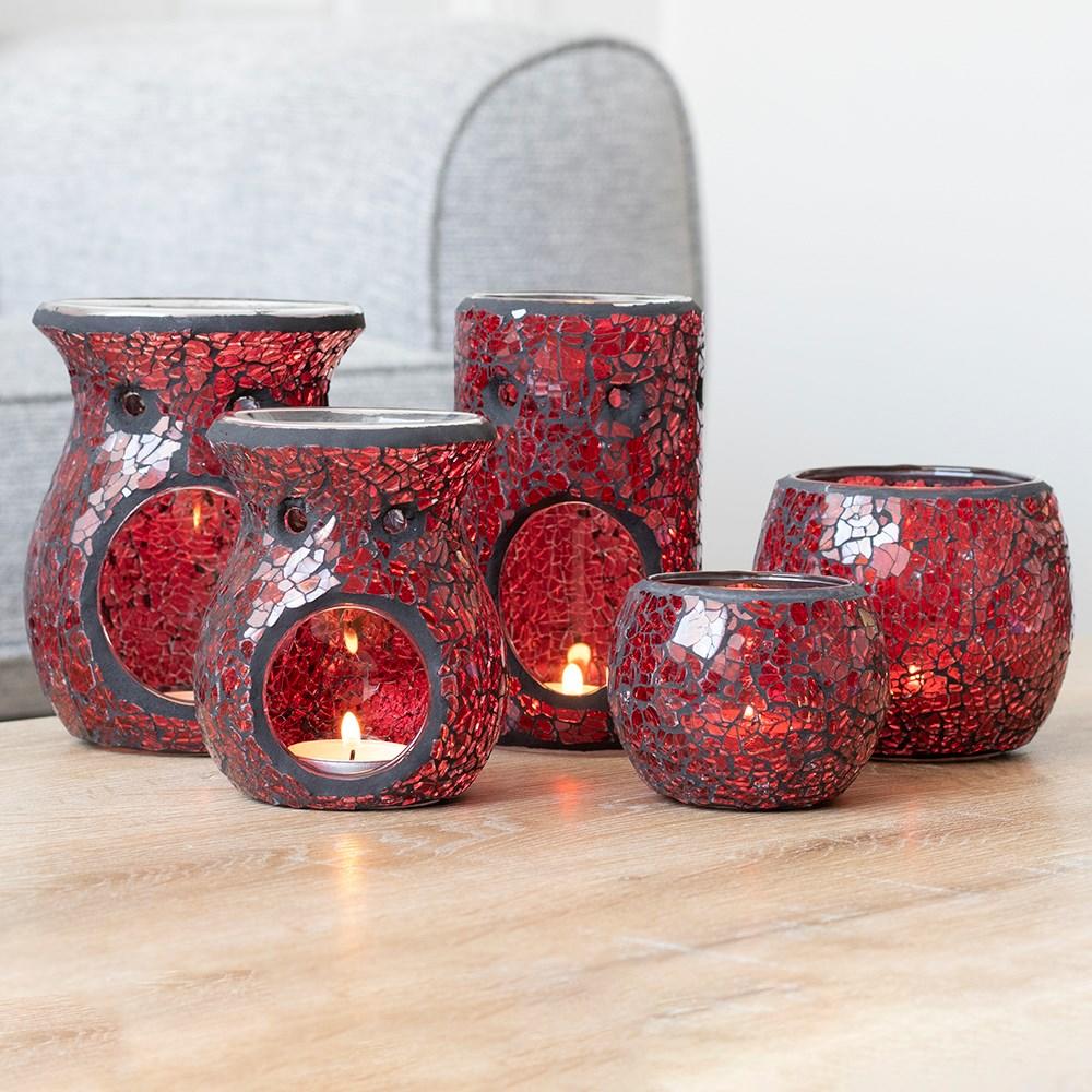 A single small red candle holder with a crackle effect, shown with other candle holders and oil burners.