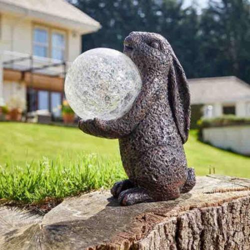 Hand painted polyresin hare garden ornament, stood upright holding a LED colour changing crackle glass gazing ball.