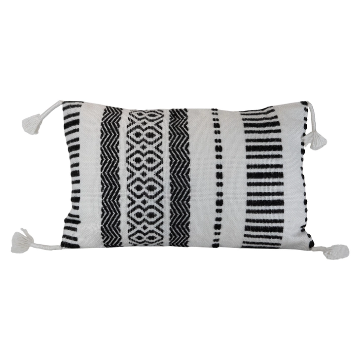 A hand woven outdoor boho cushion with a patterned mix of black and white yarns and thread wrapped corner tassels.