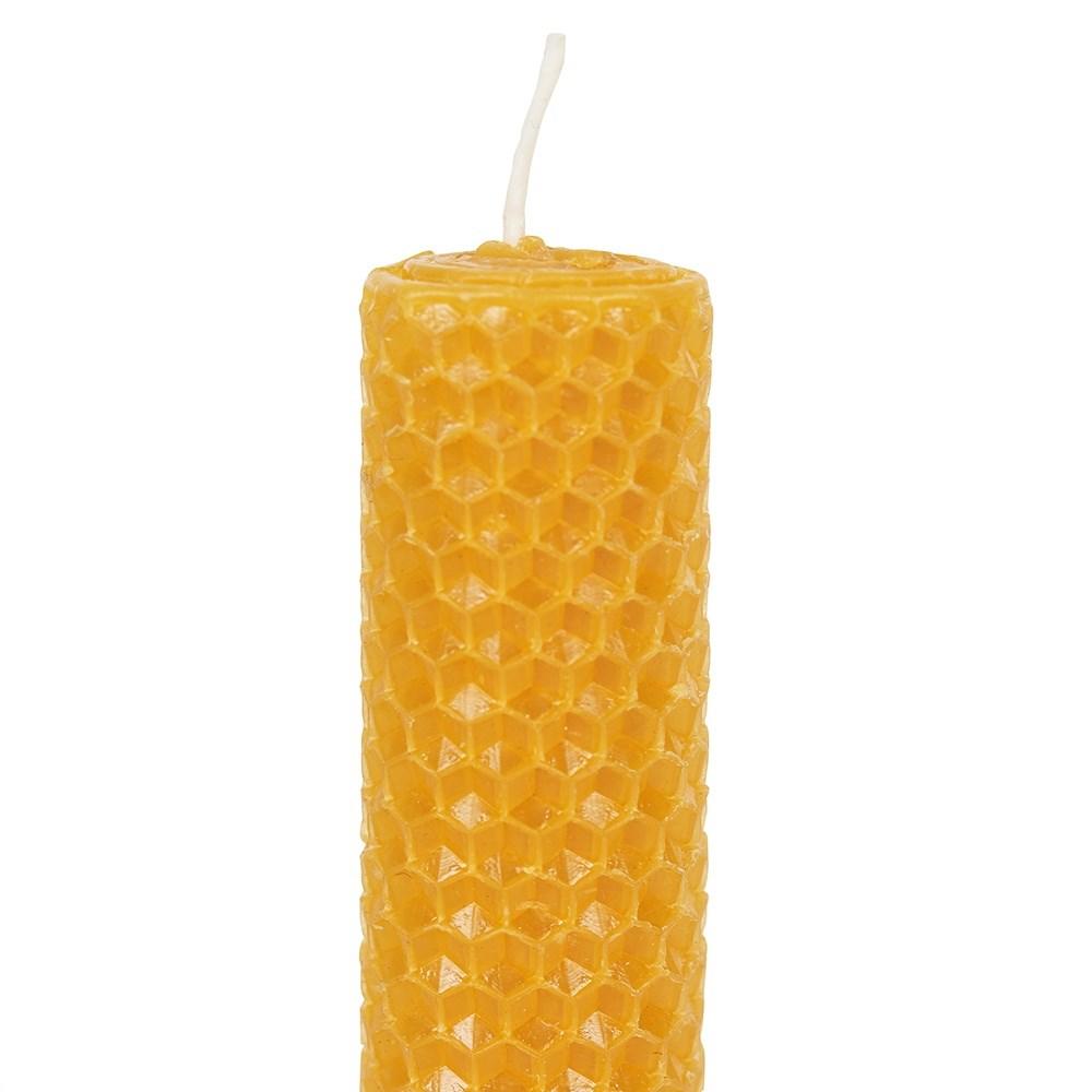 Set of three 100% natural beeswax dinner candles in a rolled honeycomb texture with a delicate honey scent, close up.