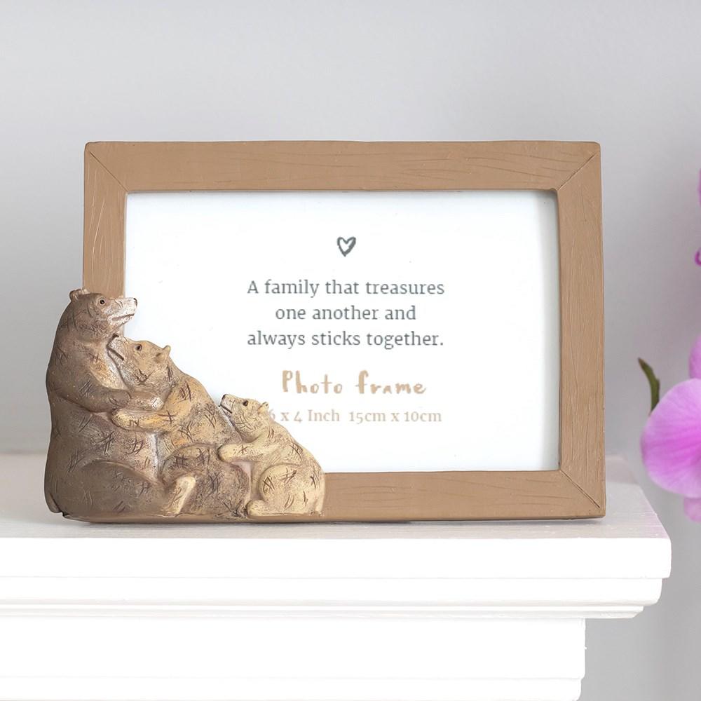 On a white mantle, Three Brown Bear Photo Frame which reads 'A family that treasures one another and always sticks together'