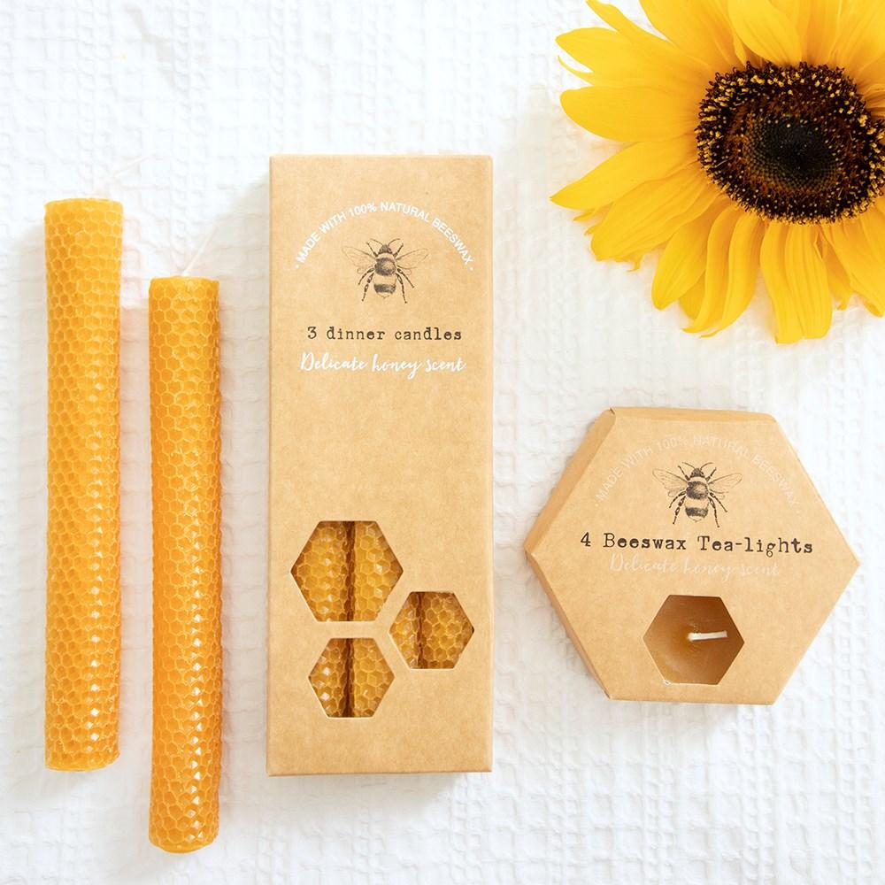 Set of three 100% natural beeswax dinner candles, rolled honeycomb texture and a delicate honey scent, shown with tealights.