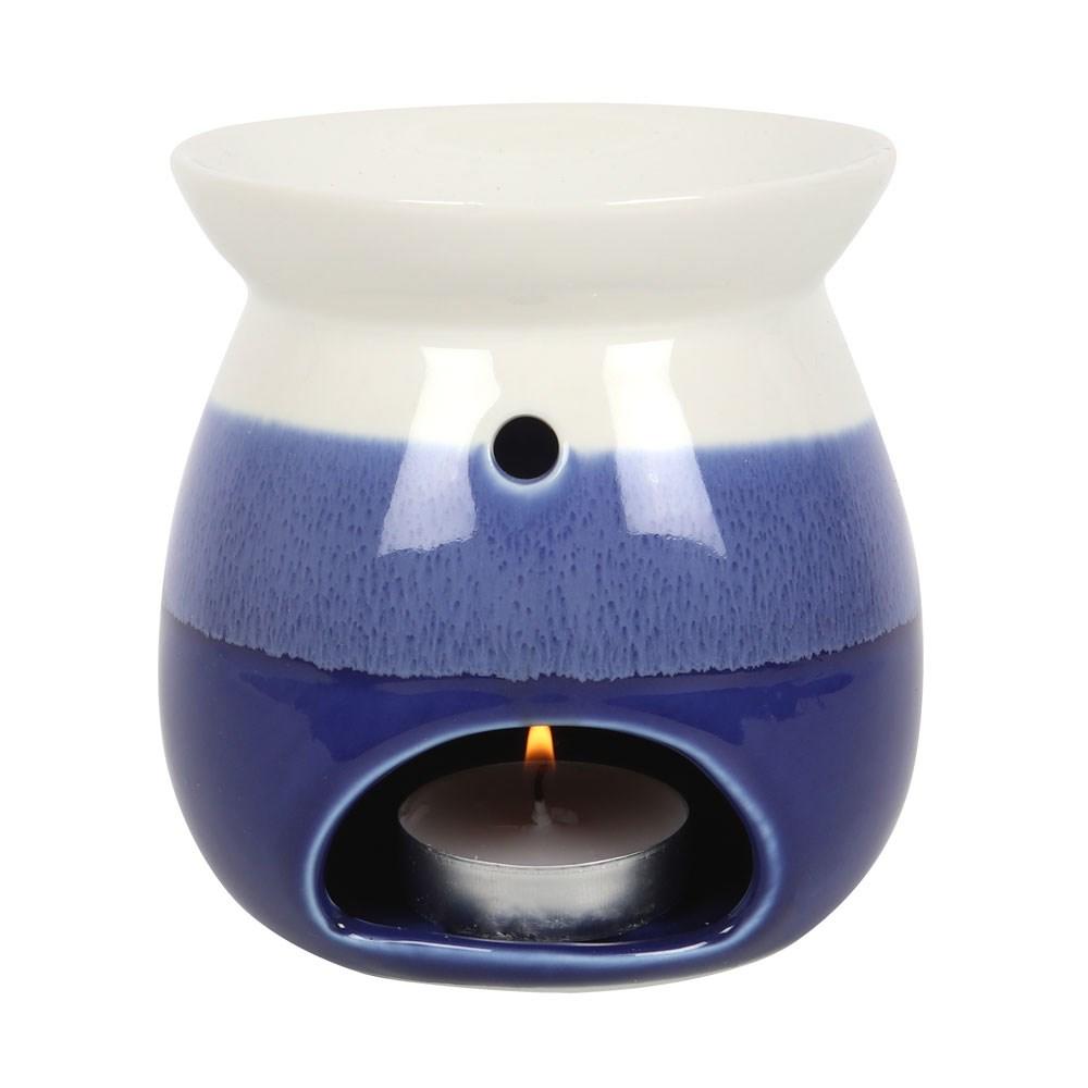 Blue and white reactive glaze oil burner and wax warmer, shown with lit tealight.