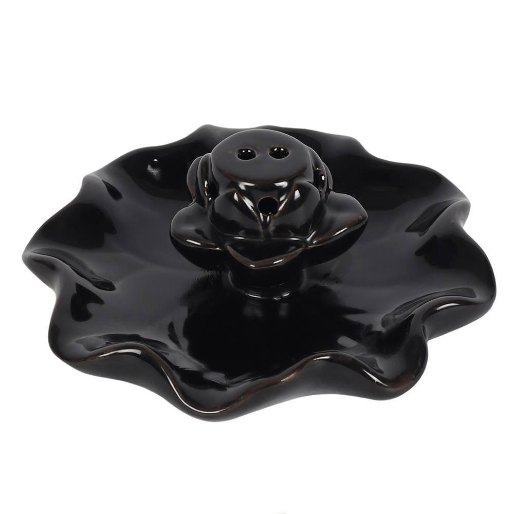 Backflow incense burner in a black ceramic lotus pool design, smoke cascades down in a waterfall effect, shown without cone.