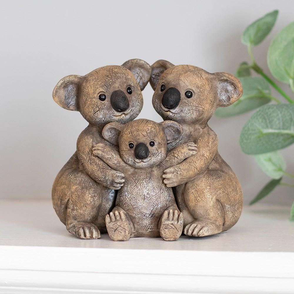 Adorable 'Koala Family' resin ornament, three koalas, shown with a leafy background.