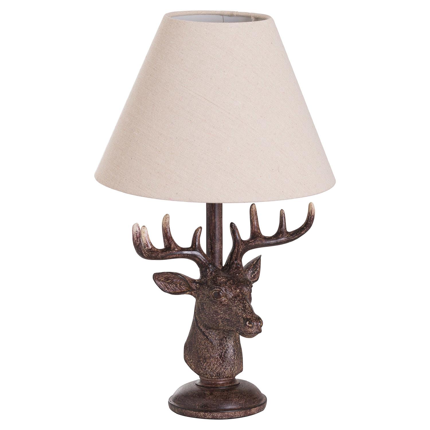 Rustic table lamp with a resin stag head base and a neutral linen shade.
